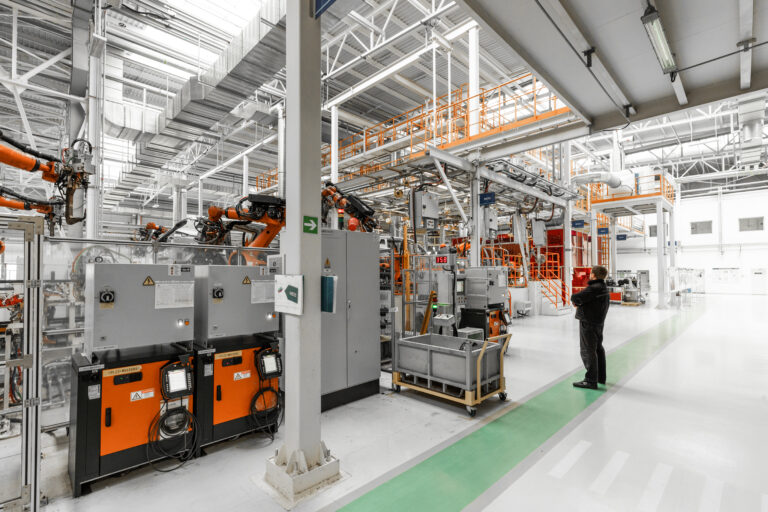 Photo of automobile production line. Welding car body. Modern car assembly plant. Auto industry